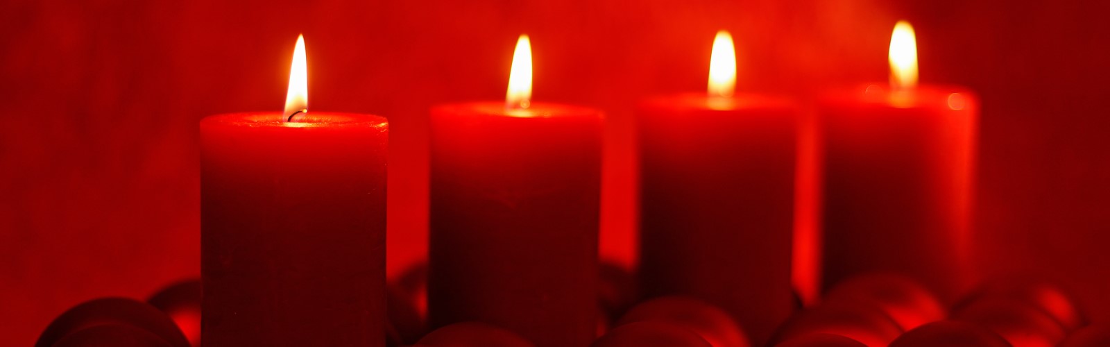 Vier brennende rote Kerzen