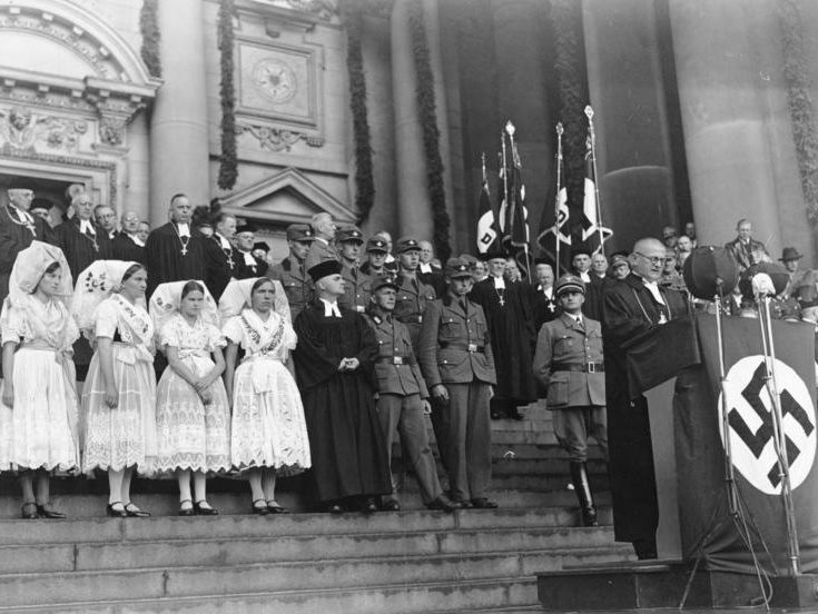 Einführung des Reichsbischofs mit Uniformierten, Geistlichen und Frauen in Trachten auf der Treppe des Berliner Domes